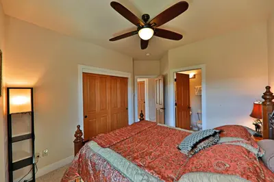 a bedroom with a bed with a ceiling fan at Luxury in Downtown Winter Park СО in Winter Park