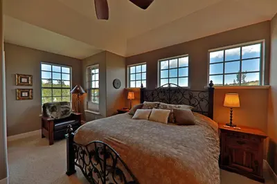 a bedroom with a large bed and windows at Luxury in Downtown Winter Park СО in Winter Park