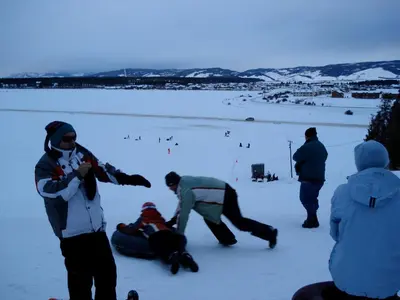 a group of people playing in the snow at Luxury in Downtown Winter Park СО in Winter Park