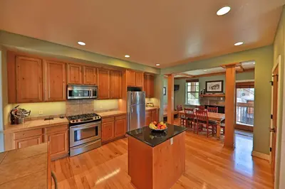 a large kitchen with wooden cabinets and a kitchen island at Luxury in Downtown Winter Park СО in Winter Park