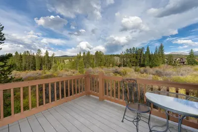 a balcony with a table and chairs on a deck at 102 Willows Way Townhouse in Winter Park