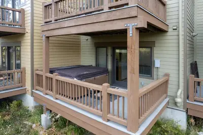 a deck with a bed on the side of a house at 102 Willows Way Townhouse in Winter Park