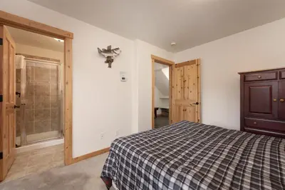 a bedroom with a bed and a closet and a door at 102 Willows Way Townhouse in Winter Park