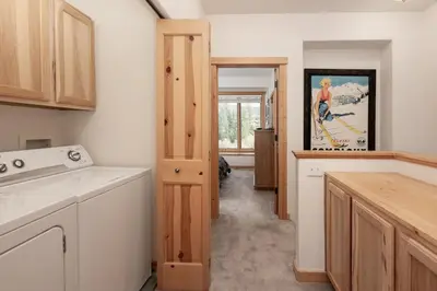 a kitchen with white cabinets and a stove top oven at 102 Willows Way Townhouse in Winter Park