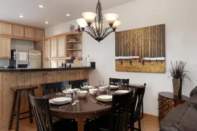 a kitchen and dining room with a wooden table and chairs at 102 Willows Way Townhouse in Winter Park