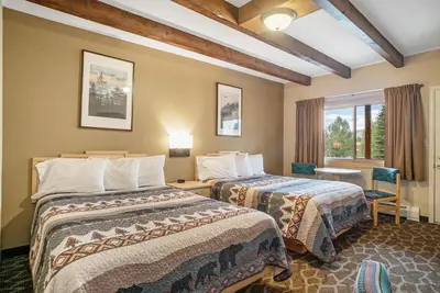 a hotel room with two beds and a window at Spirit Lake Lodge in Grand Lake