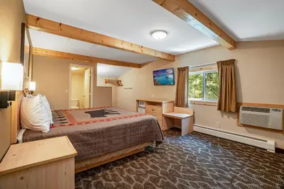 a hotel room with a bed and a desk at Spirit Lake Lodge in Grand Lake