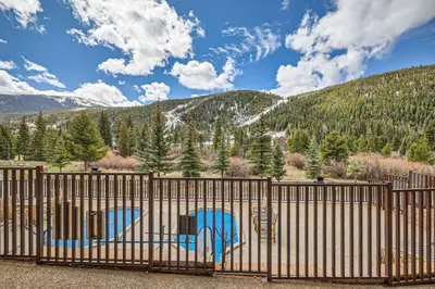 a gate with two chairs in front of a mountain at Hidden River Lodge 5945 - Keystone in Keystone