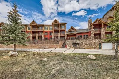 a large building with a tree in front of it at Hidden River Lodge 5945 - Keystone in Keystone