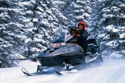 a man and woman riding on a snowmobile in the snow at Hidden River Lodge 5945 - Keystone in Keystone