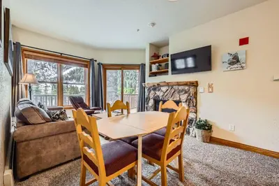 a dining room with a table and a fireplace at Hidden River Lodge 5945 - Keystone in Keystone