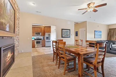 a dining room and living room with a table and chairs at Coyote Mountain Lodge in Estes Park
