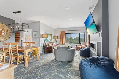 a living room with a table and a dining room at Coyote Mountain Lodge in Estes Park