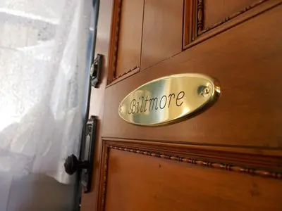 a door with a sign that says bathroom on it at Patterson Inn in Denver