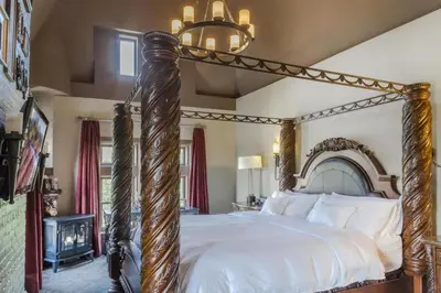 an ornate wooden canopy bed in a bedroom at Patterson Inn in Denver