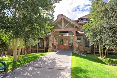 a house with a pathway leading to the front door at Highland Greens Lodge 305 Condo in Breckenridge