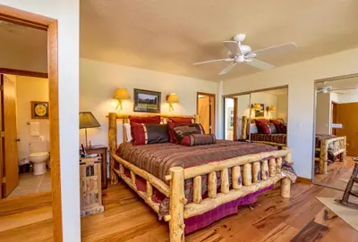 a bedroom with a bed and a ceiling fan at Tranquil Duplex Home in Estes Park