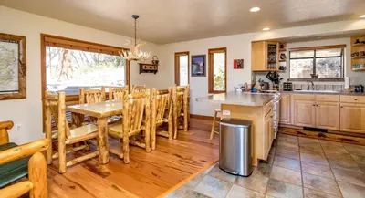 a kitchen and dining room with a table and chairs at Tranquil Duplex Home in Estes Park