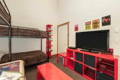 a living room with a flat screen tv and bunk beds at Snowblaze Condos Building A unit 33 in Winter Park