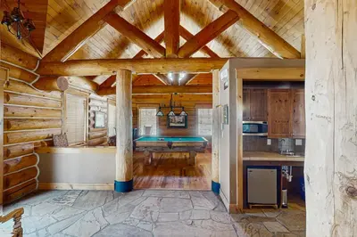 a kitchen in a log cabin with a ceiling at Settler's Creek 6524 in Keystone