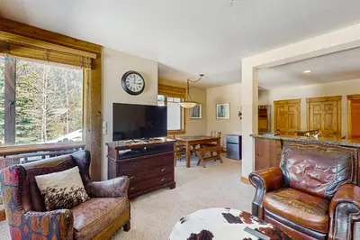 a living room with a couch and a tv at Settler's Creek 6524 in Keystone