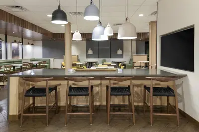 a kitchen with a large island with bar stools at Fairfield Inn & Suites by Marriott Fort Collins South in Fort Collins