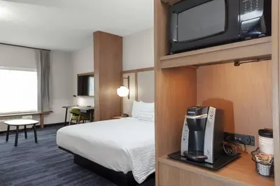 a hotel room with a bed and a tv at Fairfield Inn & Suites by Marriott Fort Collins South in Fort Collins
