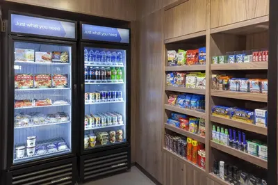 a grocery store aisle with two refrigerators and drinks at Fairfield Inn & Suites by Marriott Fort Collins South in Fort Collins