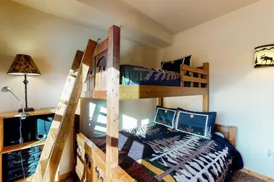 a bedroom with two bunk beds in a room at Tenderfoot Lodge 2621 in Keystone