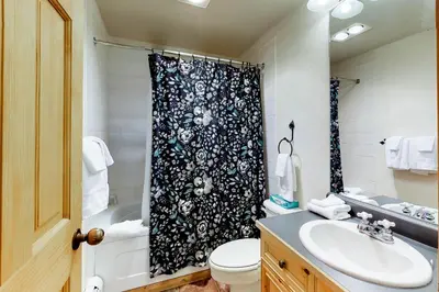 a bathroom with a black and white shower curtain at Tenderfoot Lodge 2621 in Keystone