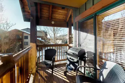 a screened in porch with a table and chairs on it at Tenderfoot Lodge 2621 in Keystone