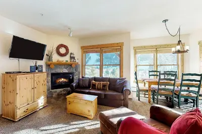 a living room with a couch and a fireplace at Tenderfoot Lodge 2621 in Keystone