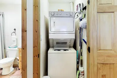 a small kitchen with a washer and dryer in a room at Tenderfoot Lodge 2621 in Keystone