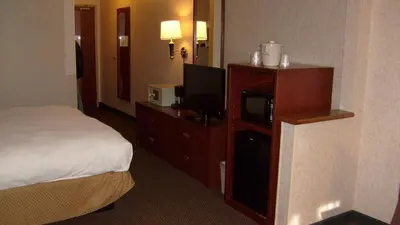 a hotel room with a bed and a flat screen tv at Baymont by Wyndham Golden/Red Rocks in Lakewood
