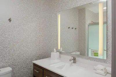 a bathroom with a sink and a mirror at Home2 Suites By Hilton Denver South Centennial Airport in Centennial