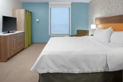 a hotel room with a large bed and a television at Home2 Suites By Hilton Denver South Centennial Airport in Centennial