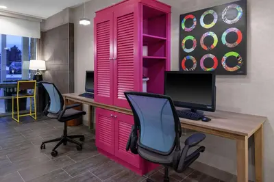 an office with a pink cabinet and a desk with a computer at Home2 Suites By Hilton Denver South Centennial Airport in Centennial