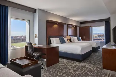a hotel room with two beds and a desk at SpringHill Suites by Marriott Denver Downtown in Denver