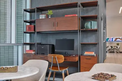 a room with a desk with a computer on a shelf at SpringHill Suites by Marriott Denver Downtown in Denver