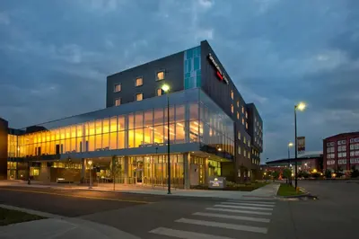 a large building with glass windows on a street at SpringHill Suites by Marriott Denver Downtown in Denver