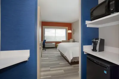 a hotel room with a bed and a tv at Holiday Inn Express & Suites - Denver NE - Brighton by IHG in Brighton