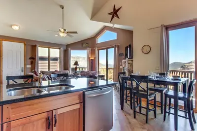 a kitchen and living room with a table and chairs at The Twin Owls 21A Condo in Estes Park