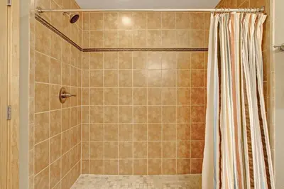 a shower with a shower curtain in a bathroom at Sheep Mountain 20B Condo in Estes Park