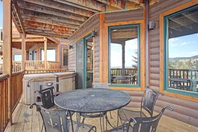 a patio with a table and chairs on a deck at Sheep Mountain 20B Condo in Estes Park