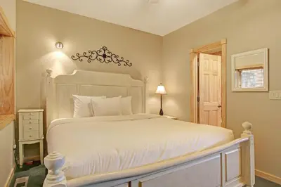 a bedroom with a large white bed and a window at Sheep Mountain 20B Condo in Estes Park