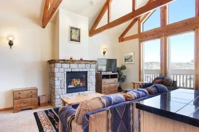 a living room with a couch and a fireplace at Comanche Peak 39 Condo in Estes Park