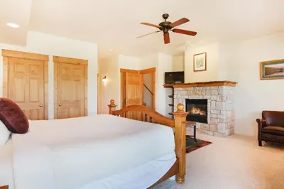 a bedroom with a bed and a fireplace at Comanche Peak 39 Condo in Estes Park