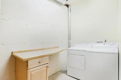 a bathroom with a sink and a washing machine at Comanche Peak 39 Condo in Estes Park