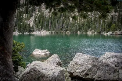 a view of a lake with rocks in the water at Bighorn Mountain 19B Condo in Estes Park