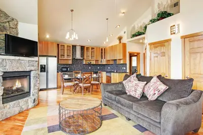 a living room with a couch and a fireplace at Mount Cairns 16A Condo in Estes Park
